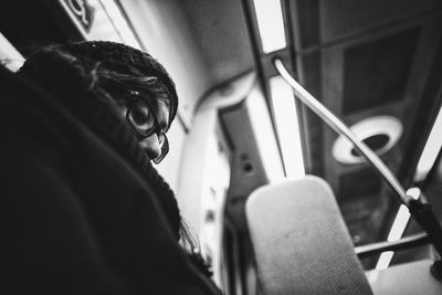 Low angle view of woman sitting in train