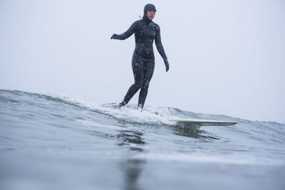 Woman surfing during winter snow