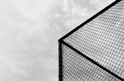 Low angle view of fence against sky