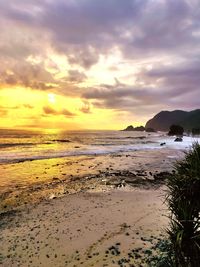 Scenic view of beach against sky during sunset