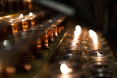 Close-up of lit tea light candles in temple