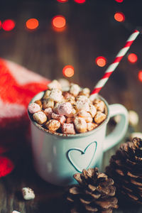 High angle view of christmas decorations with marshmallows in cup on table