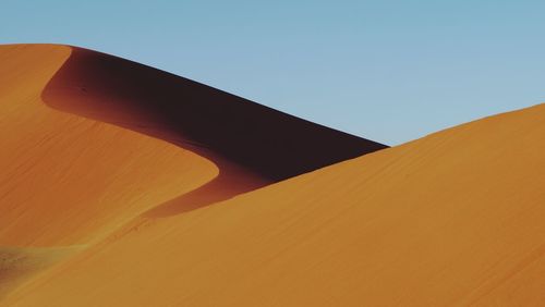 Low angle view of desert against clear sky