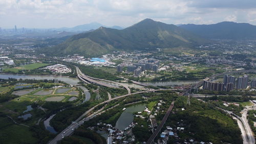 High angle view of city by buildings against sky