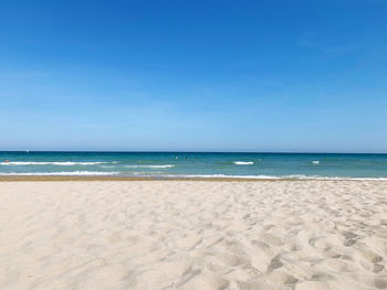 Scenic view of beach against clear blue sky