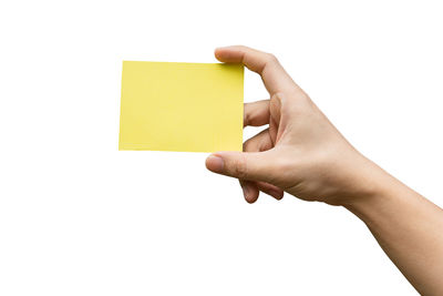 Midsection of person holding paper against white background