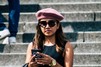 Portrait of young woman using mobile phone outdoors
