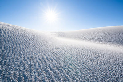 Scenic view of snow covered land against clear sky