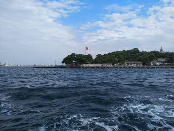 Scenic view of sea against buildings