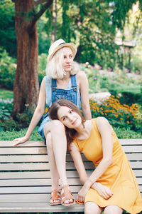 Friends spending leisure time while sitting outdoors