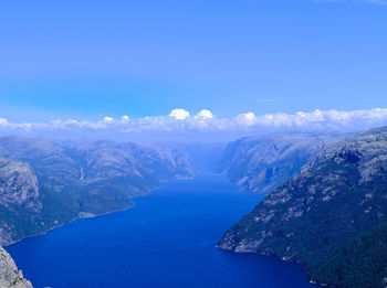 Scenic view of mountains against blue sky