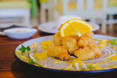 Close-up of orange slice in plate