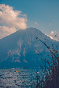 Scenic view of sea and mountains against sky