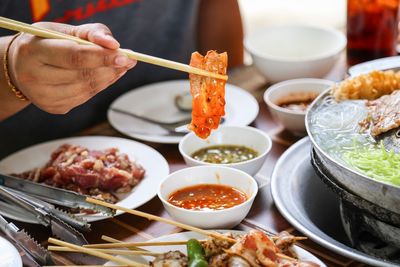 Midsection of person having food at restaurant