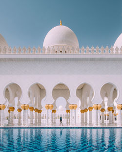 View of swimming pool by building against sky