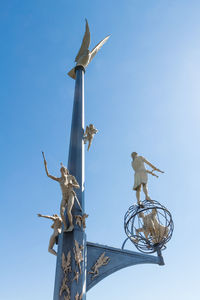 Low angle view of statue against sky