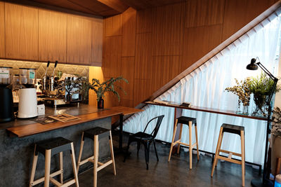 Empty chairs and tables in restaurant