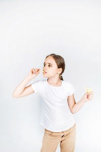 Happy girl looking away against white background