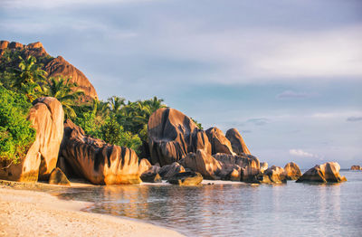 Rock formations in sea against sky