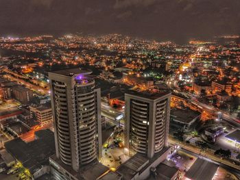 High angle view of illuminated buildings in city at night