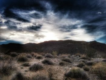 Scenic view of mountains against cloudy sky