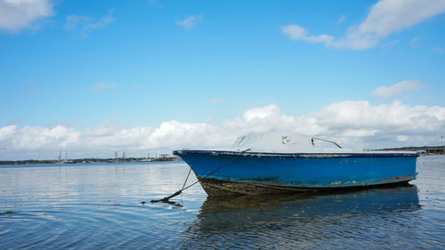 Fishing boat in sea against sky