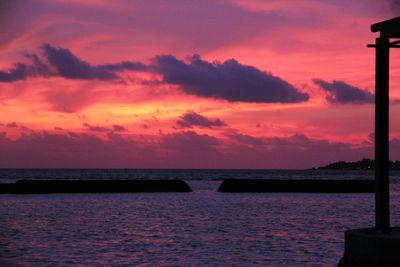 Scenic view of sea against romantic sky at sunset