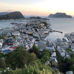 High angle view of townscape by sea against sky