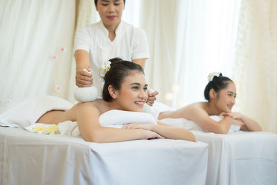 Young woman receiving massage in spa