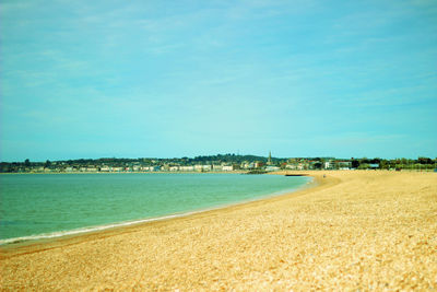 Scenic view of beach against blue sky