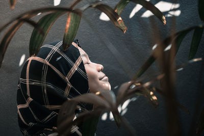 Close-up of leaves against teenage girl wearing hijab