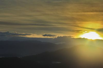 Scenic view of silhouette mountains against sky at sunset