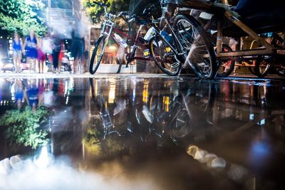 Reflection of illuminated lights in puddle