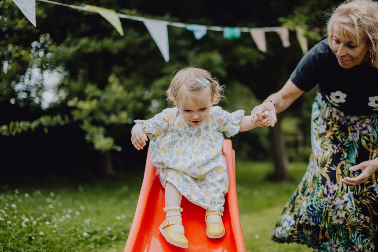 child, two people, childhood, females, real people, togetherness, family, women, plant, bonding, leisure activity, casual clothing, males, grass, girls, emotion, day, standing, front view, innocence, positive emotion, outdoors, daughter