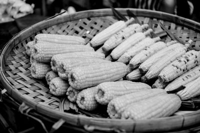 Close-up of corns in basket at market stall