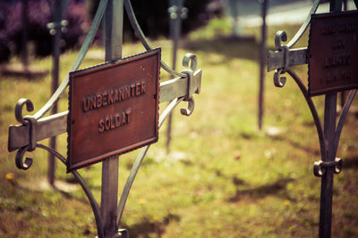 Close-up of sign board on field