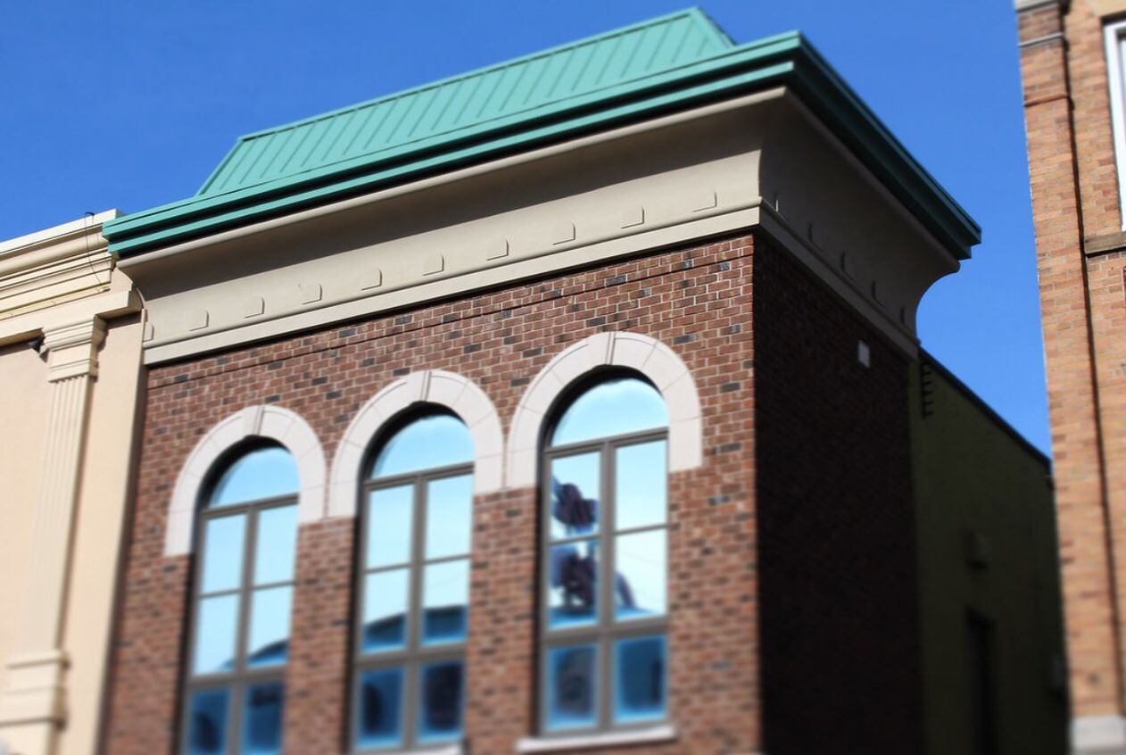 architecture, building exterior, built structure, low angle view, clear sky, window, arch, building, blue, city, residential structure, residential building, facade, day, outdoors, sunlight, no people, sky, brick wall, exterior