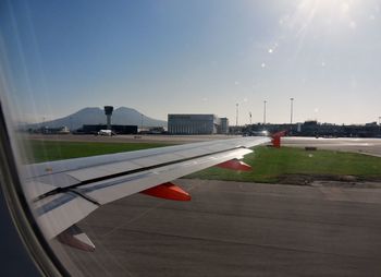 Airplane on runway against clear sky