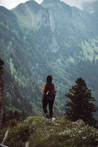 Rear view of man walking on mountain