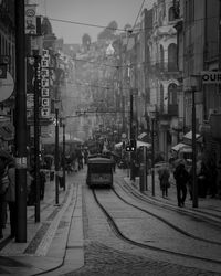 Cars on street in city against sky