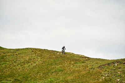 Man standing on field against sky