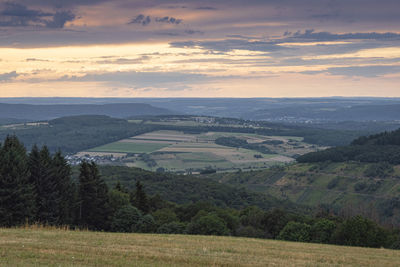 Scenic view of field against sky during sunset