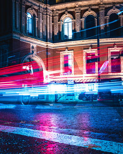 Light trails on road in city at night