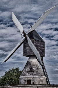 Low angle view of traditional windmill against sky