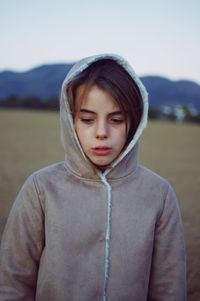 Portrait of teenage girl standing on land