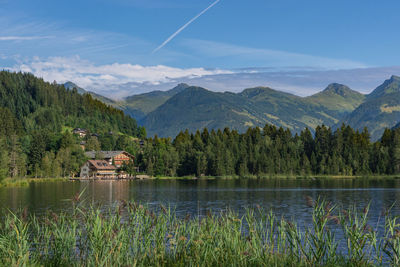 Scenic view of lake and mountains against sky