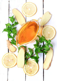 Ginger honey lemon mint on a white wooden background ingredient for homemade lemonade rustic style 
