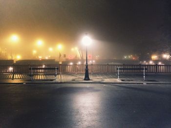 View of illuminated street lights at night