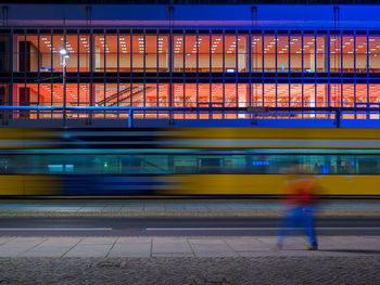 Blurred train motion in front of the dresden concert hall at night