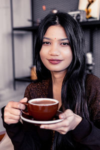 Portrait of woman drinking coffee